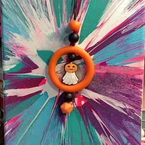 Orange and Black ghostly car charm.